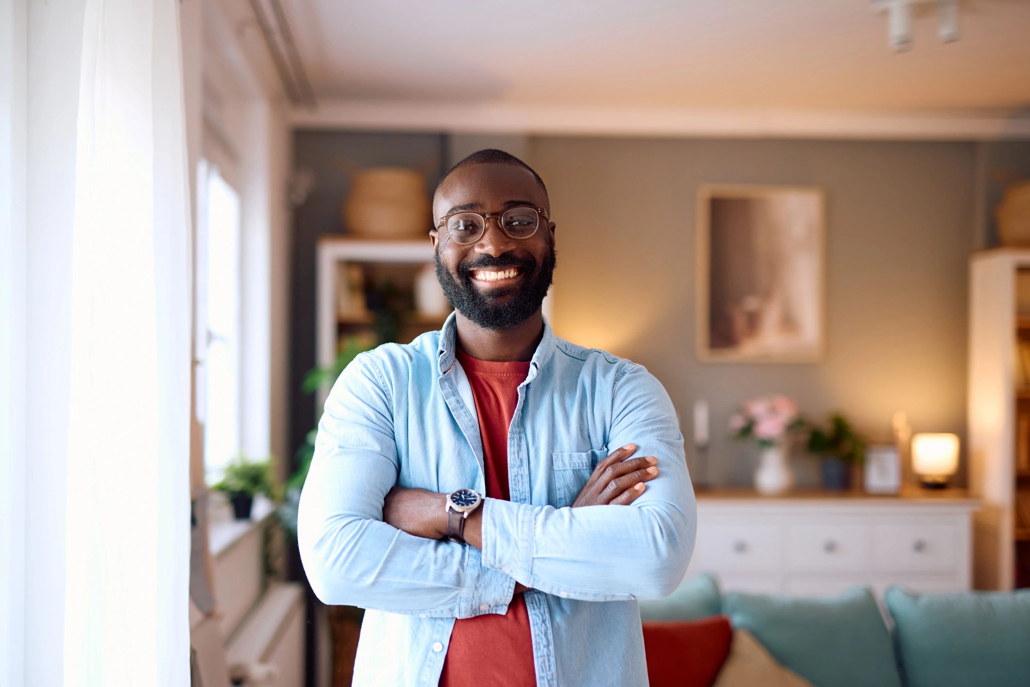 Smiling man standing confidently at home