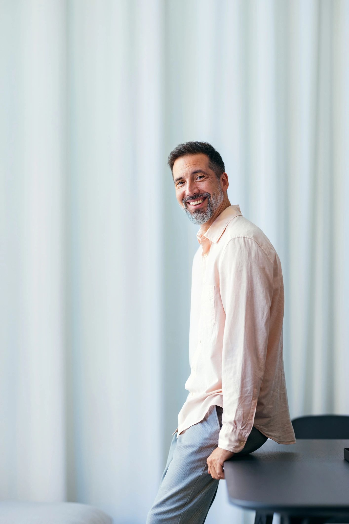 Confident middle-aged man smiling indoors